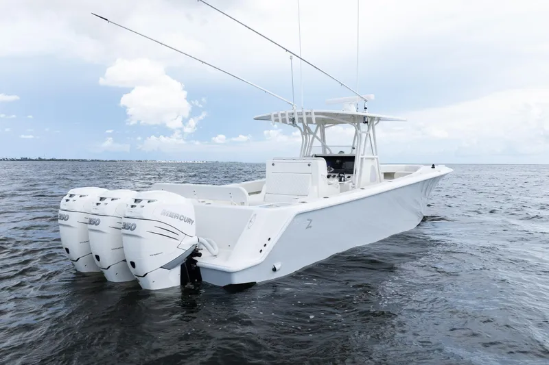 Slide: The Image of 2017 SeaVee 370z boat with triple Mercury engines on open water. - 55
