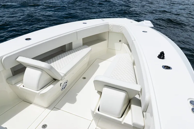 Slide: The Image of 2017 SeaVee 370z boat interior with white cushioned seating on open water. - 6