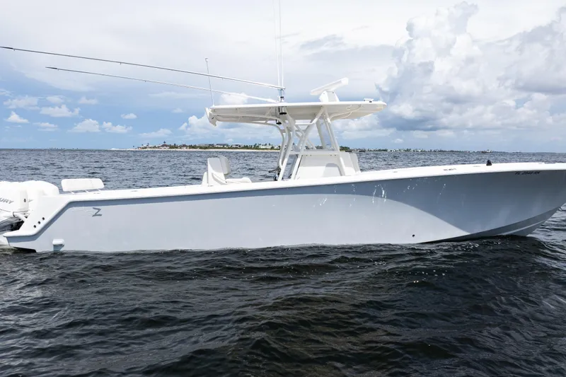 Slide: The Image of 2017 SeaVee 370z boat on open water under cloudy sky. - 60