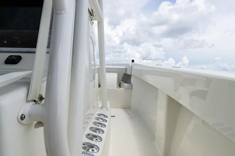 Slide: The Image of 2017 SeaVee 370z boat deck with rod holders, under a cloudy sky. - 62