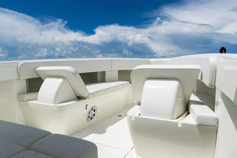 Slide: The Image of 2017 SeaVee 370z boat interior with white seating under a clear blue sky. - 8