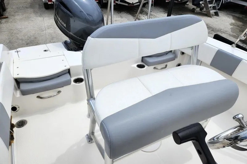 Slide: The Image of 2020 Robalo R180 Center Console boat interior with seating and Yamaha engine. - 2