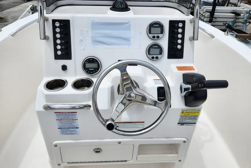 Slide: The Image of 2020 Robalo R180 Center Console boat dashboard with steering wheel and controls. - 6