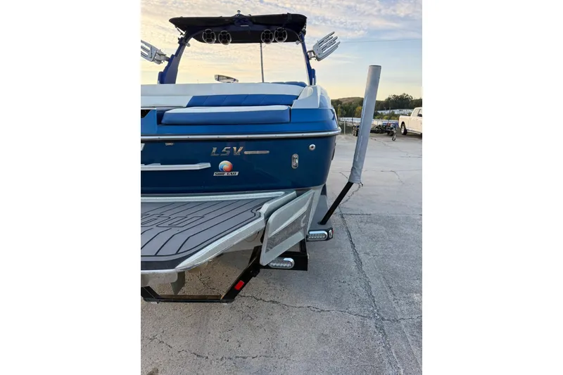 Slide: The Image of 2016 Malibu Wakesetter 25 LSV boat, blue exterior, parked on concrete surface. - 10
