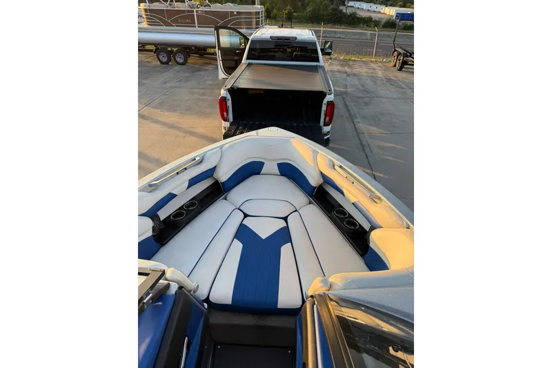 Slide: The Image of 2016 Malibu Wakesetter 25 LSV boat interior with blue and white seating. - 13