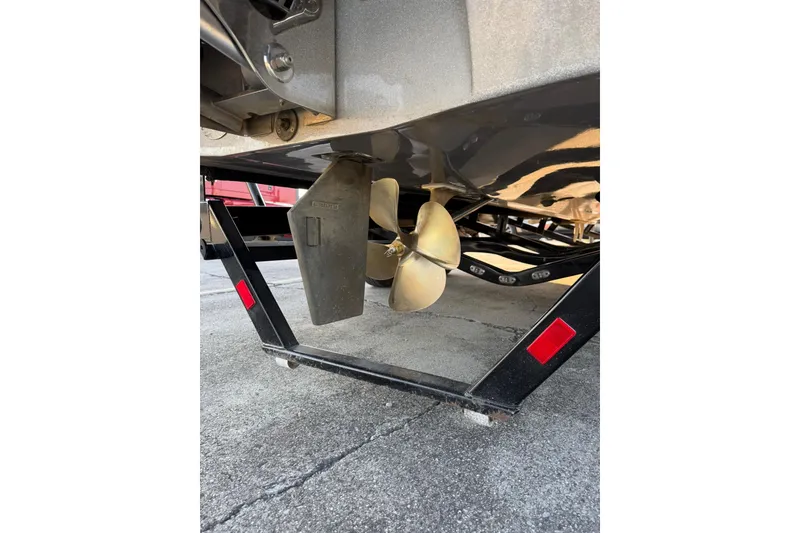 Slide: The Image of 2016 Malibu Wakesetter 25 LSV boat propeller and rudder on trailer. - 5