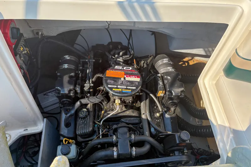 Slide: The Image of Engine compartment of a 1998 Chaparral Sunesta 210 boat, showcasing a 5.0L engine. - 14