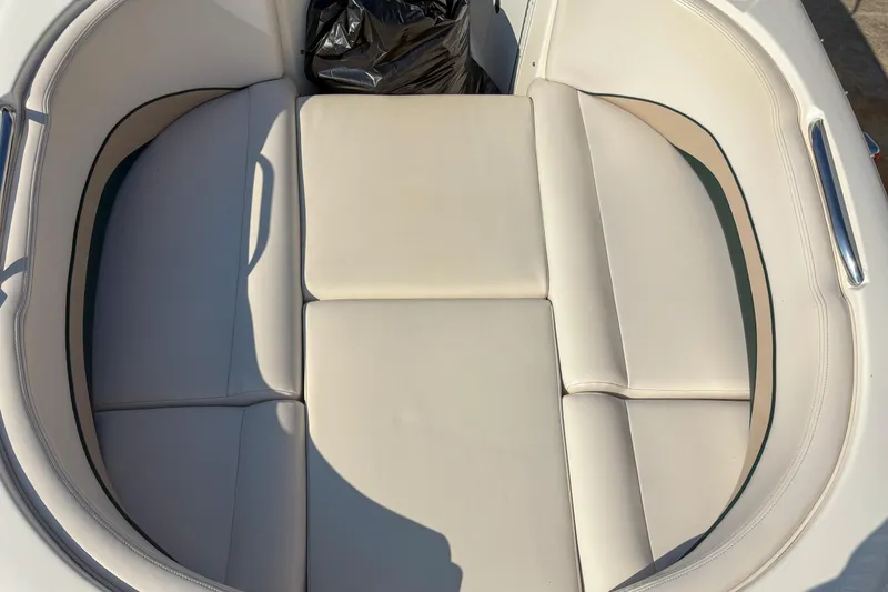 Slide: The Image of 1998 Chaparral Sunesta 210 boat interior with beige cushioned seating. - 6