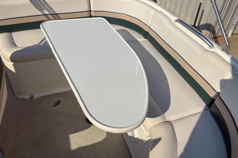 Slide: The Image of 1998 Chaparral Sunesta 210 boat interior with seating and table. - 7