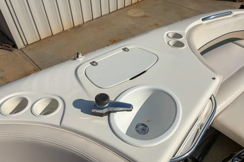 Slide: The Image of 1998 Chaparral Sunesta 210 boat interior with cup holders and faucet. - 9