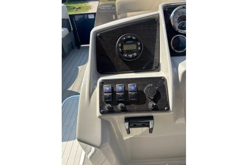 Slide: The Image of Control panel of 2023 Sylvan Mirage X X3 boat with switches and gauges. - 12