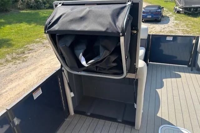 Slide: The Image of 2023 Sylvan Mirage X X3 pontoon boat with storage compartment open on deck. - 13