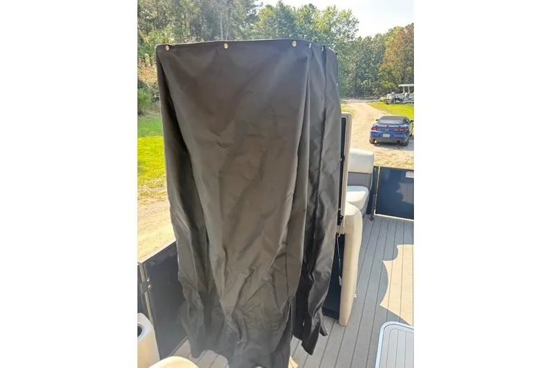 Slide: The Image of 2023 Sylvan Mirage X X3 boat with black privacy curtain on deck. - 14