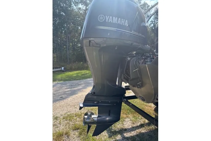 Slide: The Image of 2023 Sylvan Mirage X X3 with Yamaha outboard motor in a sunny outdoor setting. - 16