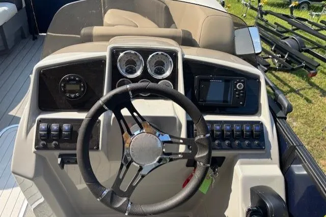 Slide: The Image of 2023 Sylvan Mirage X X3 boat dashboard with steering wheel and control panel. - 9