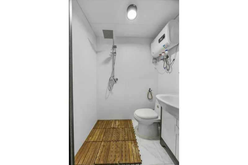 Slide: The Image of Modern bathroom with shower, toilet, wooden floor, and water heater, Gospel 39, 2024 model. - 12
