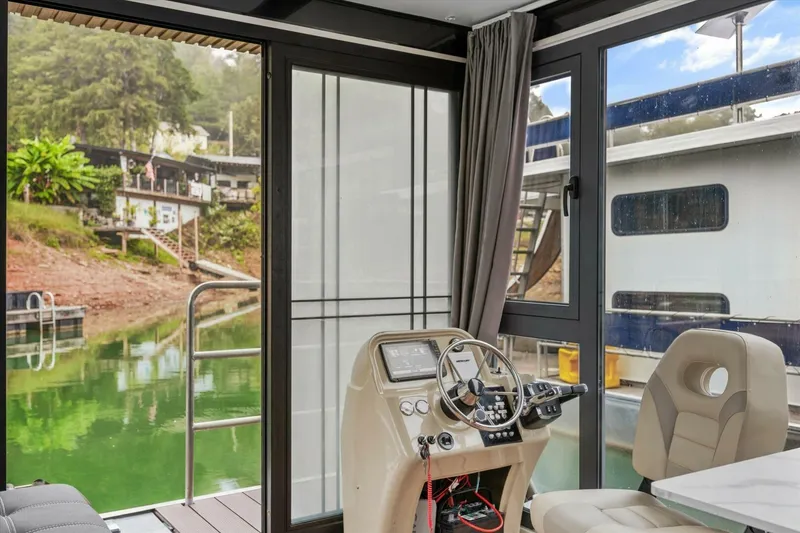 Slide: The Image of Modern Gospel 39 boat interior with steering console, large windows, and scenic waterfront view. - 13