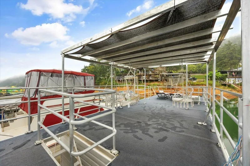 Slide: The Image of Rooftop deck of 2024 Gospel 39 boat with seating, overlooking serene waterfront. - 14