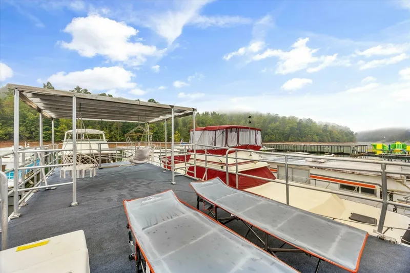 Slide: The Image of Rooftop deck of 2024 Gospel 39 houseboat with lounge chairs and scenic lake view. - 17