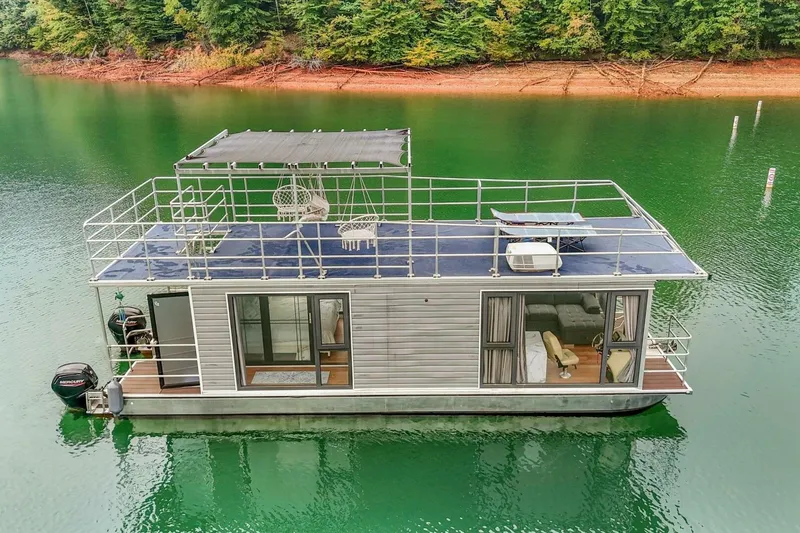 Slide: The Image of Houseboat on serene lake, Gospel 39 model, 2024, with rooftop seating and lush forest backdrop. - 19