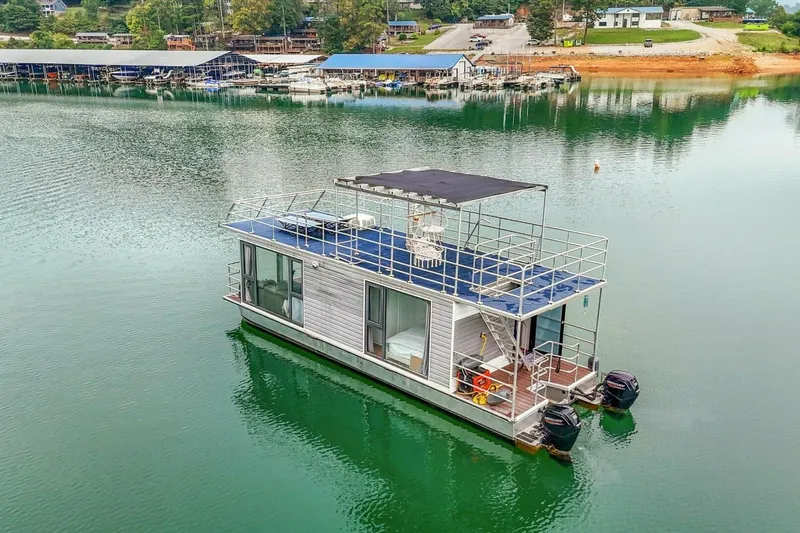 Slide: The Image of Modern 2024 Gospel 39 houseboat on tranquil lake with scenic marina backdrop. - 20
