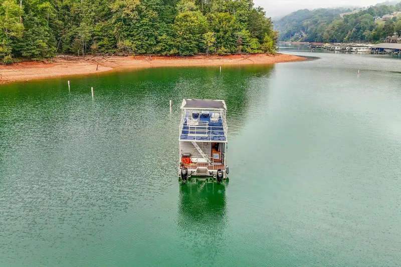 Slide: The Image of Houseboat on serene lake surrounded by lush trees, Gospel 39 model, 2024. - 22