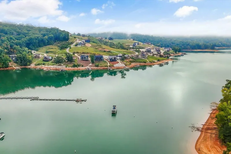 Slide: The Image of Aerial view of serene lake with surrounding homes and lush greenery, Gospel 39, 2024. - 27