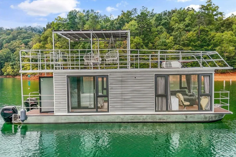 Slide: The Image of Houseboat on a serene lake, Gospel 39 model, 2024, surrounded by lush greenery. - 5
