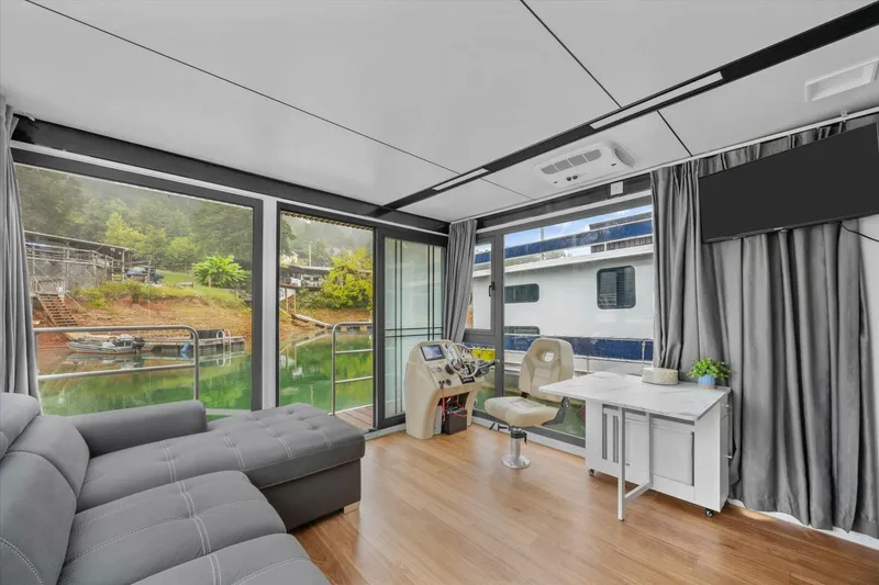 Slide: The Image of Modern interior of 2024 Gospel 39 houseboat with large windows, sofa, and steering area. - 8