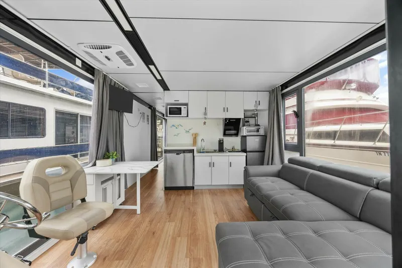 Slide: The Image of Modern houseboat interior with kitchen, sofa, and helm; Gospel 39, 2024 model. - 9