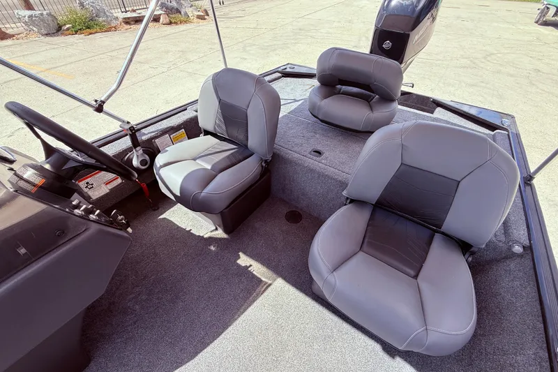 Slide: The Image of 2025 Bass Tracker Classic XL boat interior with steering wheel and navigation equipment. - 11