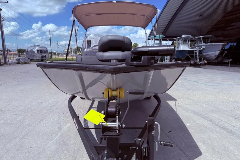 Slide: The Image of 2025 Bass Tracker Classic XL boat with canopy on trailer, parked outdoors. - 3