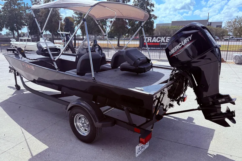 Slide: The Image of 2025 Bass Tracker Classic XL boat with outboard motor, parked on a trailer. - 5