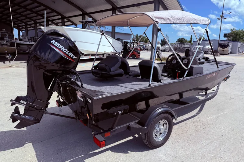Slide: The Image of 2025 Bass Tracker Classic XL boat interior with seating and steering console. - 7