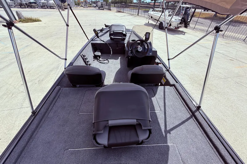 Slide: The Image of 2025 Bass Tracker Classic XL boat interior with seat and trolling motor. - 8