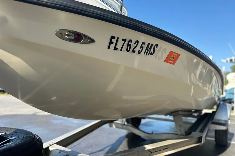 Slide: The Image of 2004 Hells Bay 18 Marquesa boat on trailer, Florida registration visible. - 10