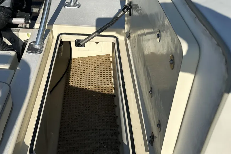 Slide: The Image of Open storage compartment on a 2004 Hells Bay 18 Marquesa boat. - 15