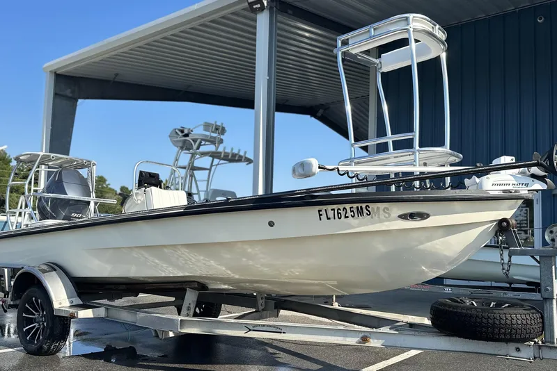 Slide: The Image of 2004 Hells Bay 18 Marquesa boat on trailer under a metal canopy. - 2