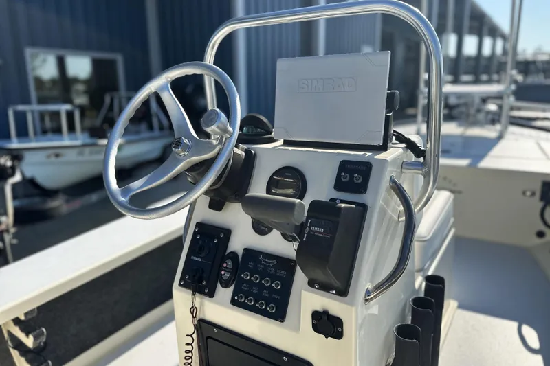 Slide: The Image of 2004 Hells Bay 18 Marquesa boat console with steering wheel and navigation equipment. - 5