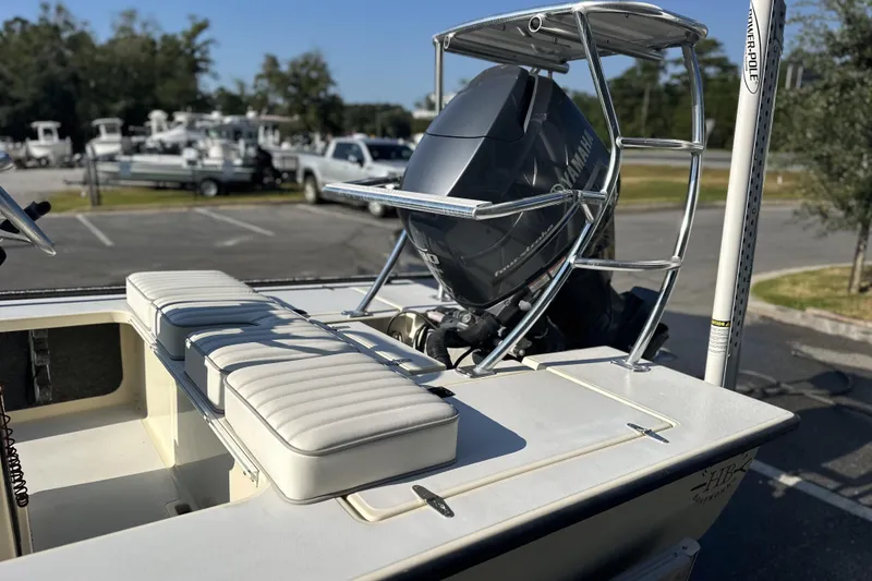 Slide: The Image of 2004 Hells Bay 18 Marquesa boat with Yamaha engine in a parking lot. - 9