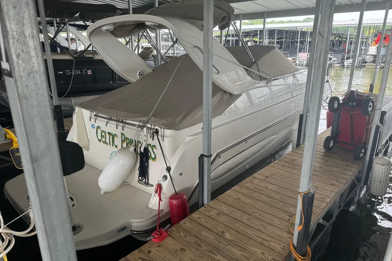 Slide: The Image of 2000 Maxum 2900 SCR boat docked, featuring red mooring lines and registration number TX 3737 RB. - 2