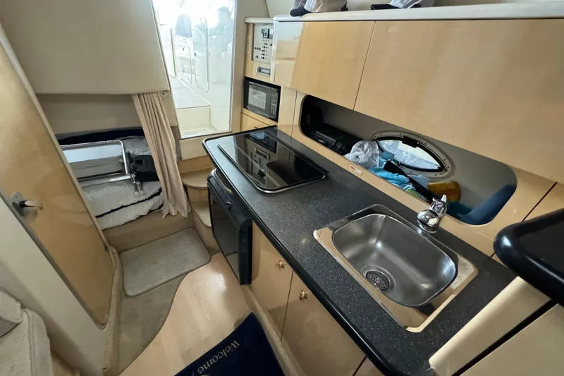 Slide: The Image of Compact bathroom in 2001 Maxum 2900 SCR boat with sink and porthole. - 8