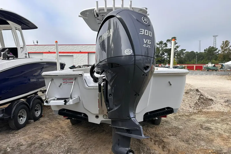Slide: The Image of 2025 Sportsman Masters 247OE Bay Boat with Yamaha 300 V6 engine, parked outdoors. - 16