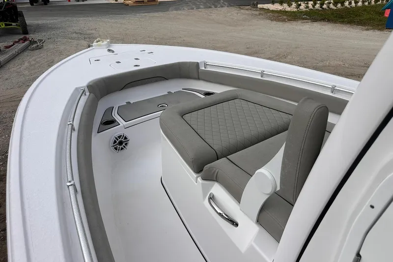 Slide: The Image of 2025 Sportsman Masters 247OE Bay Boat interior with gray seating and speaker. - 32
