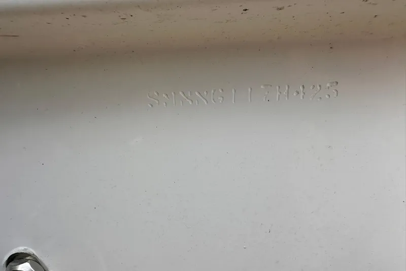 Slide: The Image of 2025 Sportsman Masters 247OE Bay Boat hull identification number on white surface. - 38