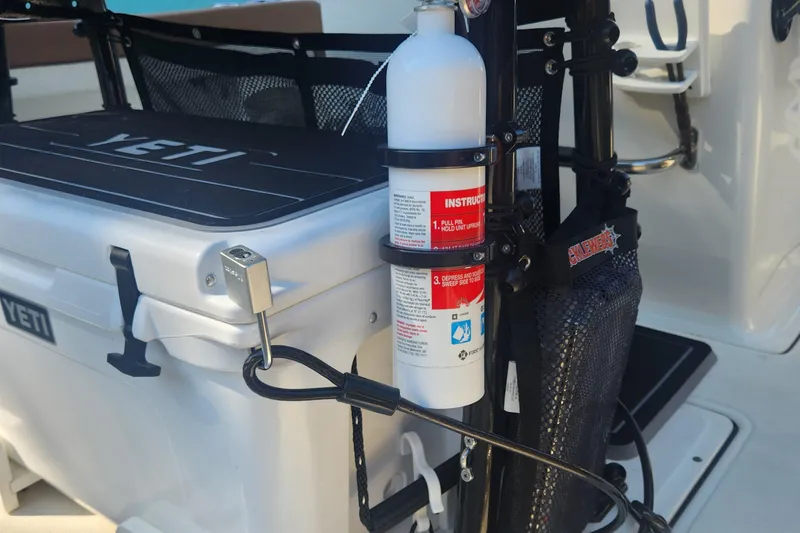 Slide: The Image of Fire extinguisher and YETI cooler on 2022 Pioneer 222 Islander boat deck. - 12