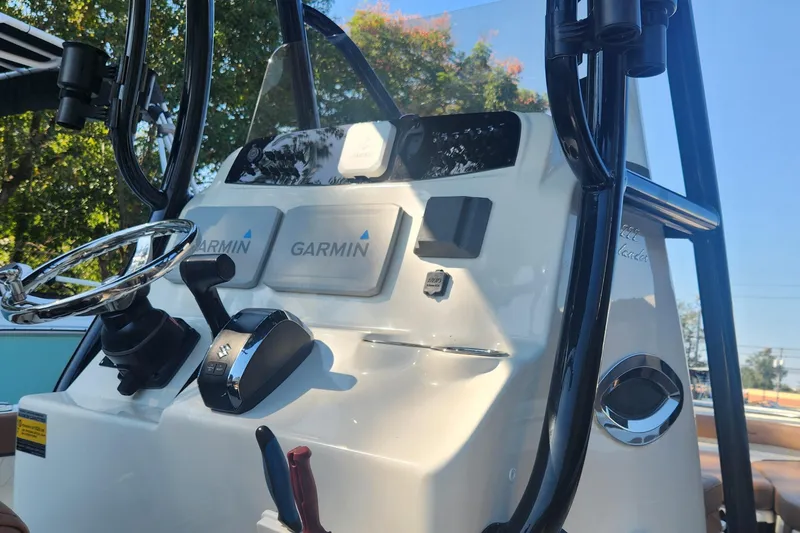 Slide: The Image of 2022 Pioneer 222 Islander boat console with Garmin navigation and Suzuki controls. - 14