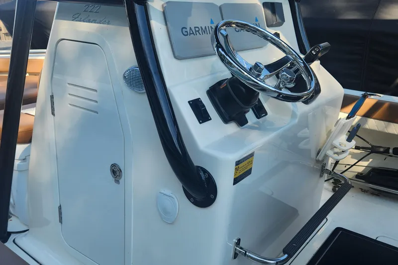 Slide: The Image of 2022 Pioneer 222 Islander boat console with Garmin navigation and steering wheel. - 17