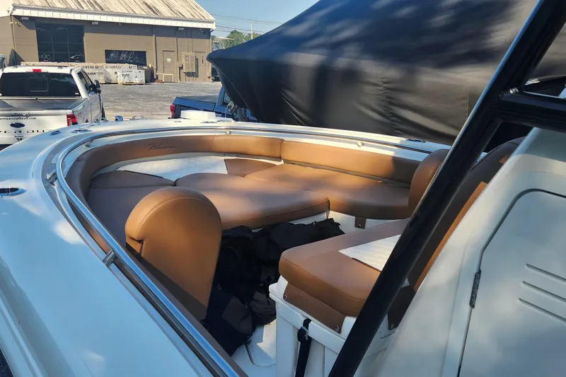Slide: The Image of 2022 Pioneer 222 Islander boat with tan seating in a marina setting. - 21