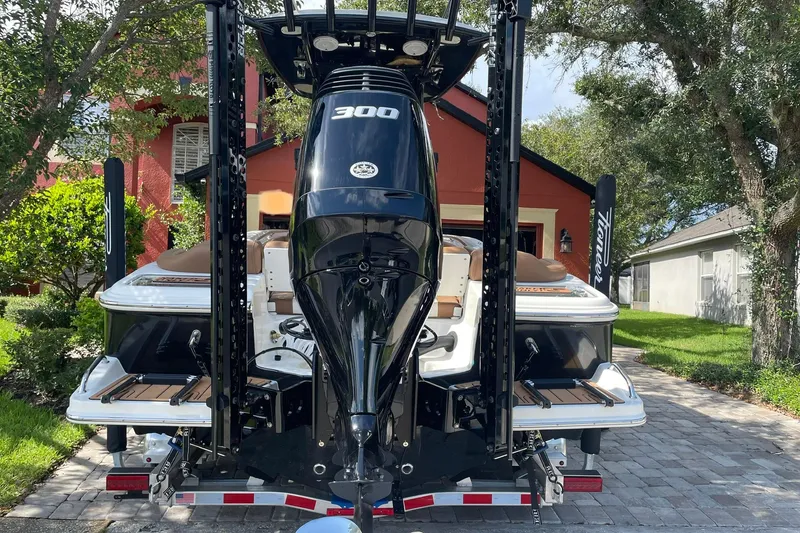 Slide: The Image of 2022 Pioneer 222 Islander boat with powerful 300 HP engine, parked on a driveway. - 3